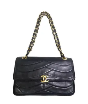80's vintage Chanel black 2.55 shoulder bag with wavy stitches and rope strings and gold chain strap. Very rare piece from the era